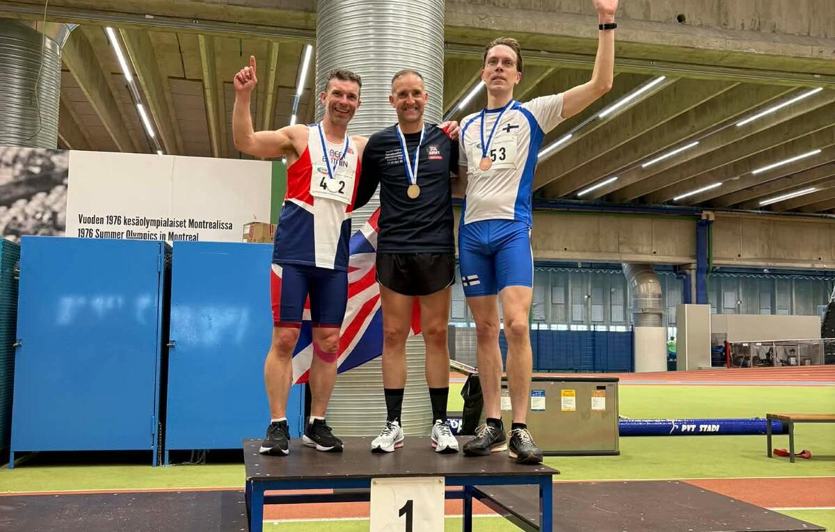 Rick Cordwell (left) on the podium after winning the silver medal at the world Tetradecathlon