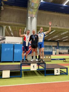Rick Cordwell (left) on the podium after winning the silver medal at the world Tetradecathlon